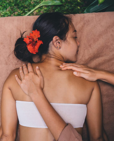 Relaxed female lying at desk enjoying original thai massage in spa from professional masseur spending weekend time for herself and mediation, Asian client have rejuvenation procedure for refreshing